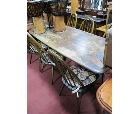 Six (Four Singles and Two Carvers) Ercol Comb Back Dining Chairs and Table, on trestle ends. 