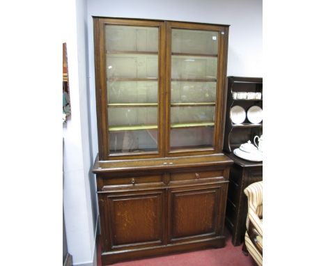 Early XX Century Oak Bookcase, with a glazed top, adjustable shelves, base with two small drawers, over panelled cupboard doo