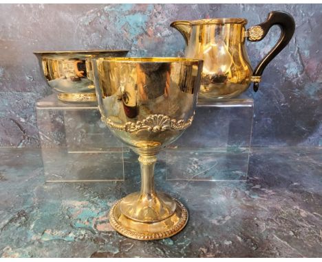 A silver plated goblet, Garrard &amp; Co, Ltd. applied with anthemion and scrolls, 15cm high, 4004;&nbsp; an Asprey milk jug 