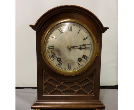 A late 19th century mahogany mantel clock, with Roman numerals, twin winding holes, eight day movement, arched case with blin