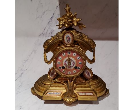 A French gilt metal mantel clock, H T Brevet,&nbsp; set with porcelain panels, Roman numerals, twin winding holes, eight day 