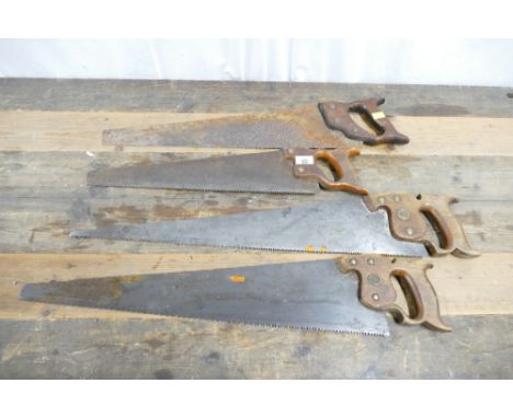 Four vintage handsaws which include 2 by Disston.