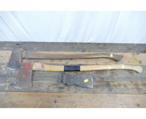 Two felling axes and one axe head.  This bladed lot is not for sale to people under the age of 18. By bidding on this item yo
