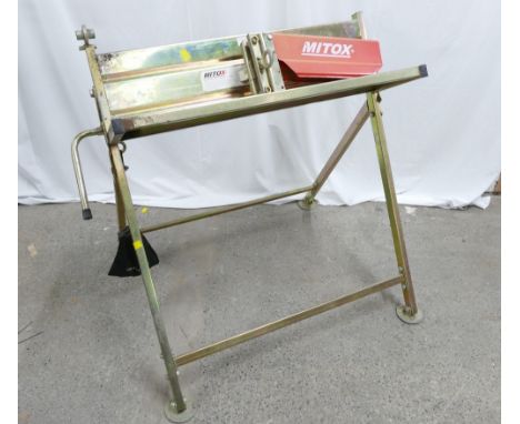 Mitox sawhorse with chainsaw holder for logging.