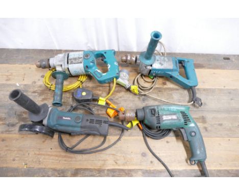 Four 110v corded power tools which include Makita angle grinder, two Makita drills and hammer drill.