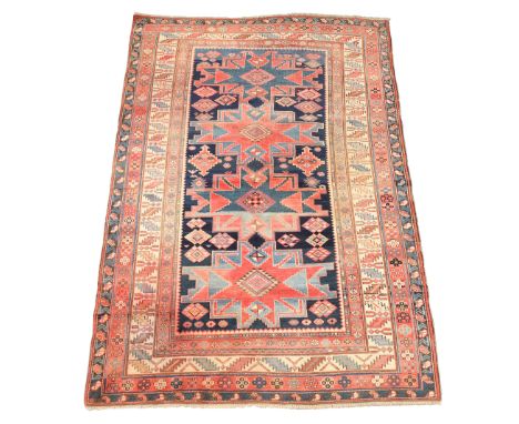A Caucasian Shirvan rug, first quarter 20th century, the central field with four geometric medallions, on a cobalt blue groun