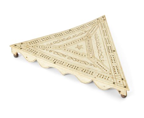 A sailor's engraved bone cribbage board, dated 1818, from the whaling brig Cretan, of triangular form with lead ball feet, th