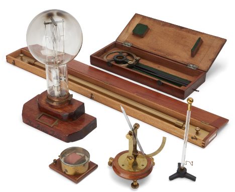 A group of maritime and scientific instruments, to include a lighthouse lightbulb, 20th century, the brass mount marked 3004 