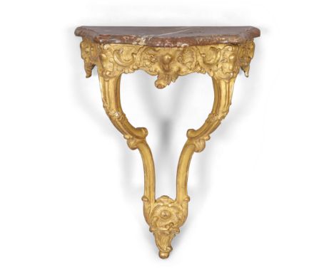 A French transitional giltwood and gesso console table, last quarter 18th century, with marble top above carved C-scroll frie