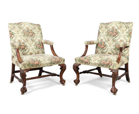 A pair of George III and later mahogany Gainsborough armchairs, last quarter 18th century and later, possibly Irish, with flo