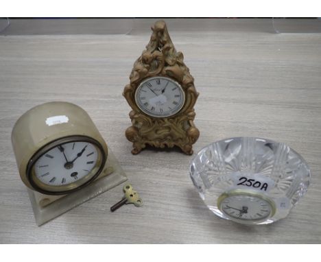 A VICTORIAN MANTEL CLOCK in an alabaster case, a clock in a cut glass case and a baroque style clock (3)