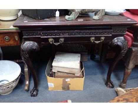 A CHIPPENDALE STYLE WRITING TABLE, the legs with claw and ball feet with Greek key blind fret frieze, fitted a drawer with mo