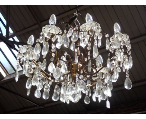 A GILT METAL EIGHT BRANCH CHANDELIER with prismatic glass drops, 47cms high, 65cms dia. 