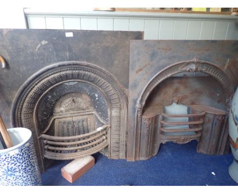 AN EARLY VICTORIAN CAST IRON FIREPLACE INSERT with hob grate within an arch, and another similar (2)