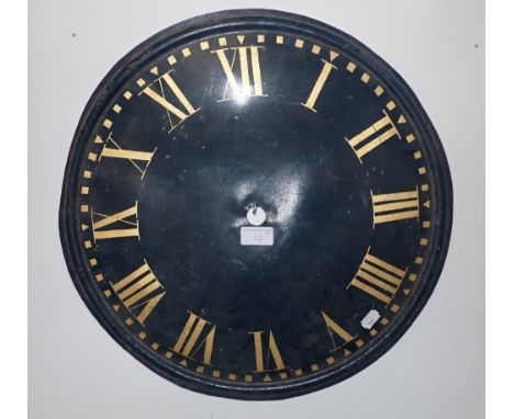 AN ARCHITECTURAL METAL CLOCK DIAL, painted blue with gilt Roman Numerals, 46cms dia.