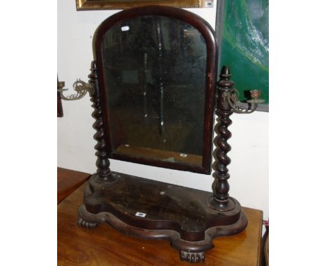 A 19th Century Mahogany Crutch Mirror, the arch top plate with spiral supports fronted by sconces,  supported on a shaped pla