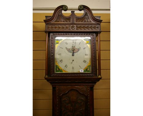 A 19th CENTURY CARVED OAK ROLLING MOON LONGCASE CLOCK by Thomas Lister, Halifax, the single glazed door hood with broken swan