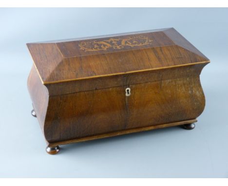 A VICTORIAN INLAID ROSEWOOD TEA CADDY of sarcophagus form, the top inlaid with scroll tied floral swags, opening to reveal a 