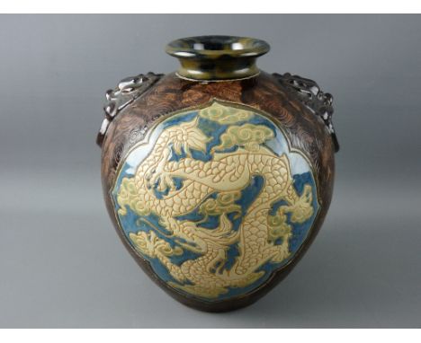 A CIRCA 1900 BULBOUS VASE decorated in the Oriental style, incised swirl decoration with mottled brown glaze and lion mask fi