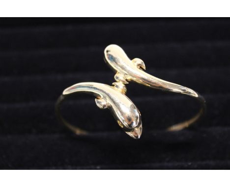 A solid 14ct gold bangle in the form of two dolphins. 14.44 grams. 
