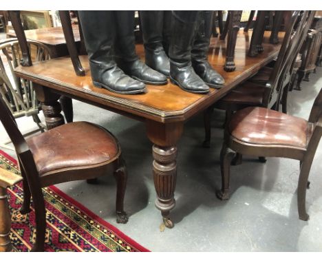 Victorian mahogany rectangular standing dining table with two extra leaves, the rectangular top with canted corners and mould