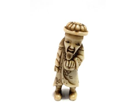 A Japanese bone netsuke, carved as a sage, length 5.5cm.