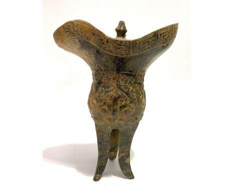A Chinese jade Chueh ritual vessel, in excavated condition, the rim with key band, the body with archaic carved decoration an