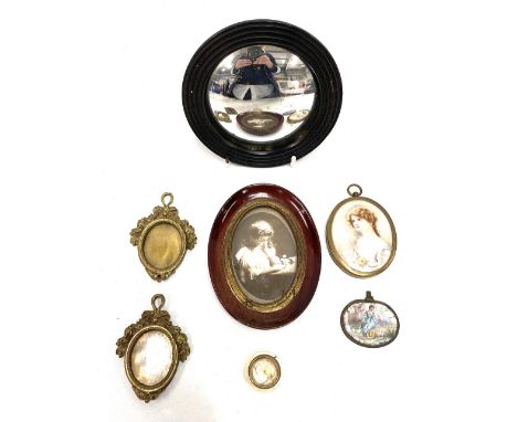 Miscellaneous items, to include a small ebony framed convex wall mirror, a pair of brass miniature frames, early 20th Century