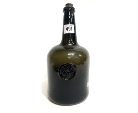 An 18th Century sealed wine bottle of squat cylindrical form, the seal with crest, height 24.5cm (cracked)