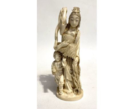 A Japanese Meiji period ivory okimono, carved as a female and boy holding a feather cloak, signed to the base, height 18cm.