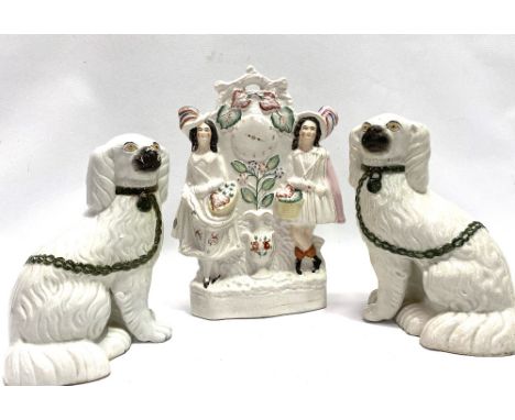 A pair of Victorian Staffordshire pottery opposing spaniels, height 23cm; together with a Staffordshire pottery flatback cloc