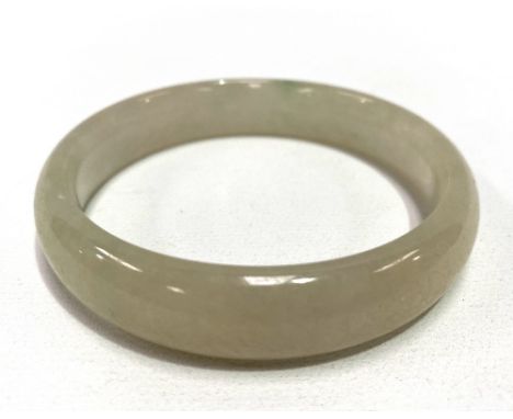 A Chinese pale celadon jade bangle of plain form, diameter 7.5cm.