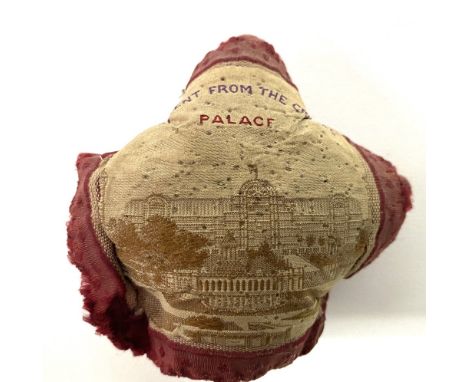 A Victorian silk pin cushion 'A PRESENT FROM THE CRYSTAL PALACE', machine embroidered with a view of the Crystal Palace.