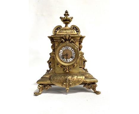 French gilt brass cased mantel clock, the ornate cast case with urn finial, the 3in gilt dial with white and black enamel Rom