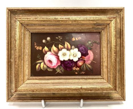 A small rectangular painted ceramic floral decorated panel, within modern frame, 12.5 x 8cm.