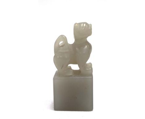 Chinese grey jade seal with faux dog finial, height 53mm.