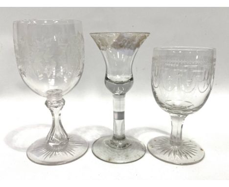 A George III funnel shaped wine glass with circular stem and foot, the rim with fruiting vine wheel engraved decoration; toge