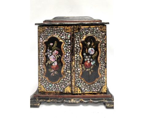 A Victorian black lacquer abalone inlaid painted and gilded jewellery cabinet, the hinged caddy top enclosing a green silk fi