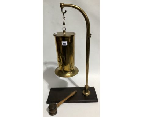 Early 20th Century brass dinner gong made from a shell cartridge and on brown Bakelite base with associated turned wood hamme