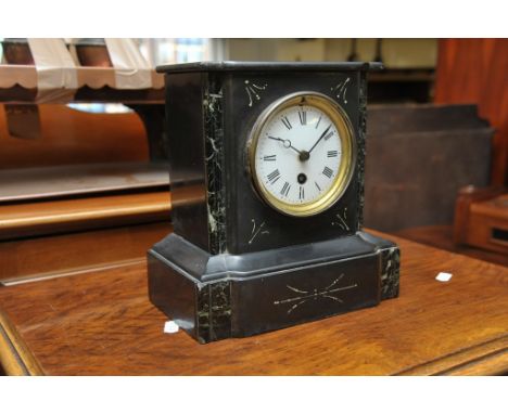 A black slate mantle clock with white enamel dial and Roman numerals