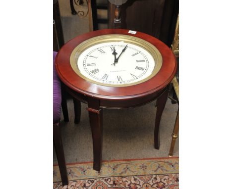 An occasional table inset with clock top