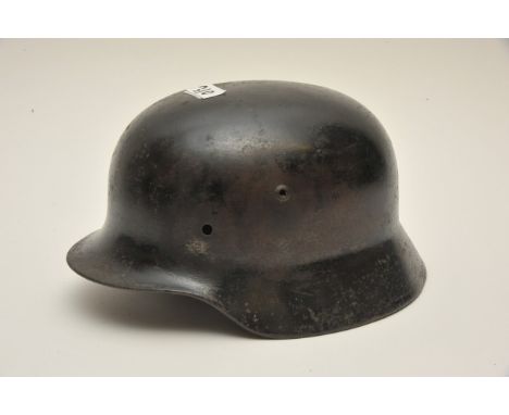 A black painted German Third Reich Stahlhelm helmet