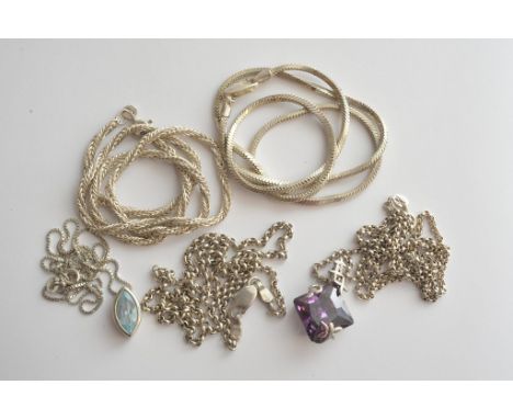 A collection of silver chains and two pendants, one inset with an amethyst colour stone