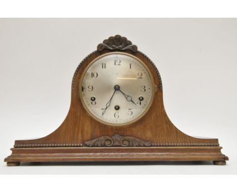A large oak cased mantle clock with key and pendulum