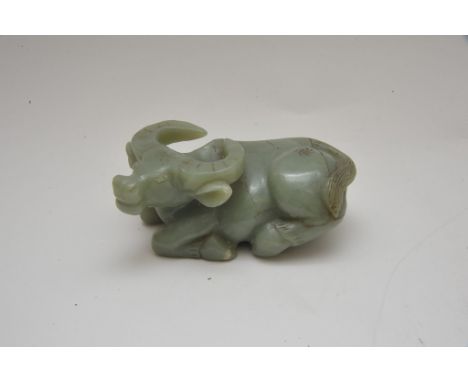 A Chinese jade carving in the form of a reclining water buffalo. Length: 12.5cm approximately
