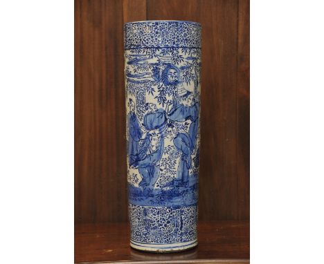 A large Japanese blue and white Arita porcelain stick stand decorated with figures and foliage