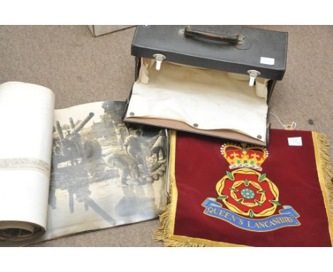 A collection of black and white military photographs, empty first aid case, bugle and pendant