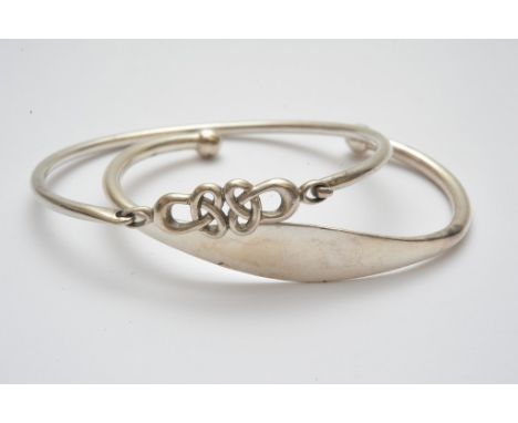 A silver bangle of Celtic design and one other