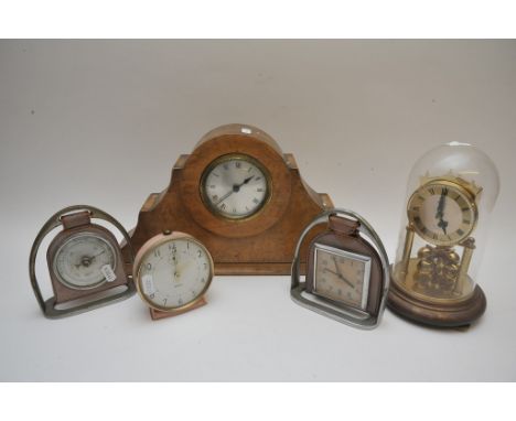 A collection of clocks various, including a clock and barometer set in a stirrup