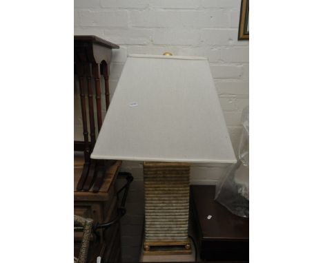 A modern design lamp of square shape with a gilded base